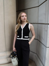 A blonde girl wears a striped chenille vest cardigan